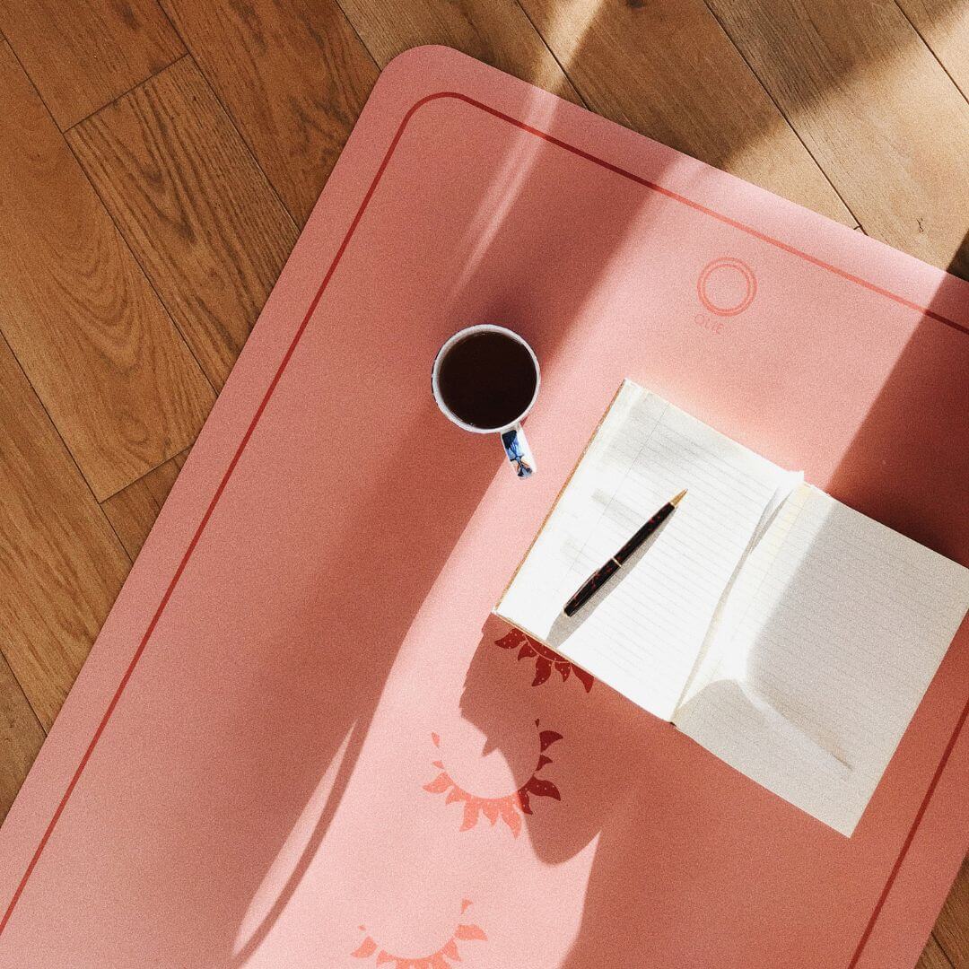 journal on top of yoga mat with coffee. Journal Prompts for Moms